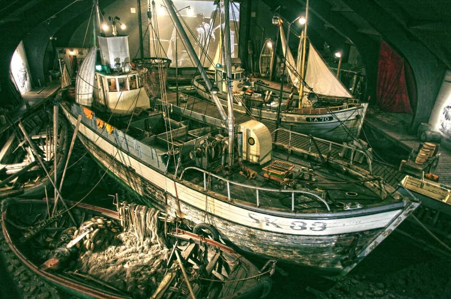 Historic herring fishing boats inside the Herring Era Museum in North Iceland