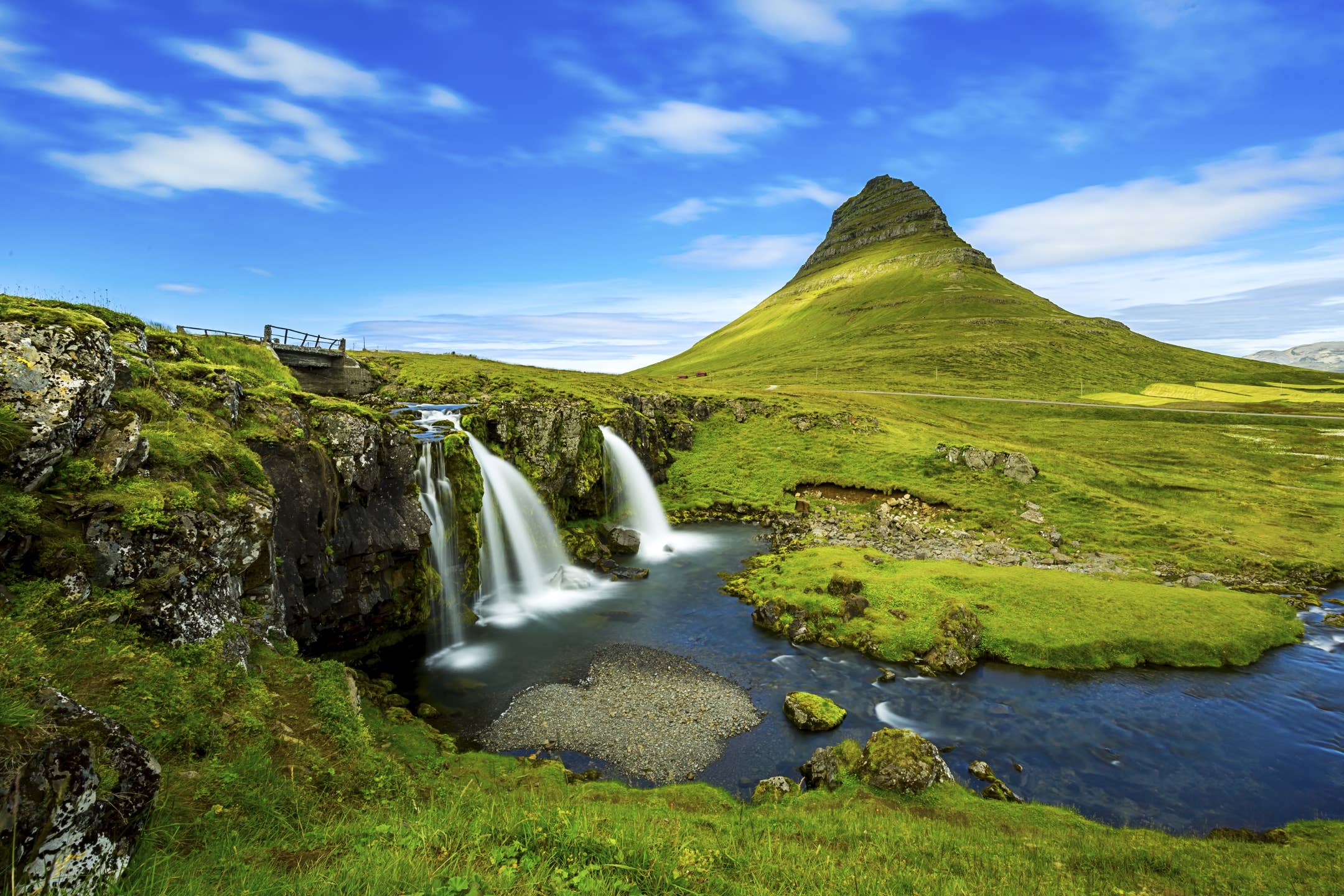 Kirkjufellsfoss Waterfall with Kirkjufell Mountain on the Snaefellsnes Peninsula.