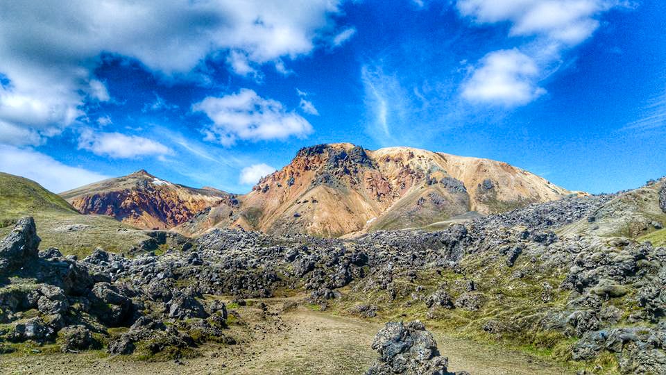 The rugged landscape of Landmannalaugar, with a Super Jeep ready for adventure against the backdrop of multicolored rhyolite mountains.