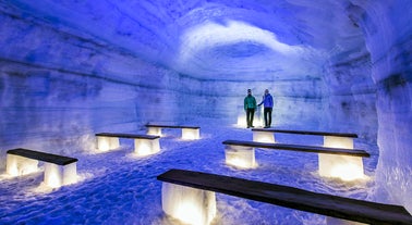 Travelers walk through the beautiful Langjokull glacier's tunnels.