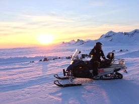 A snowmobile rider posing for a photo atop Iceland's Langjokull glacier.