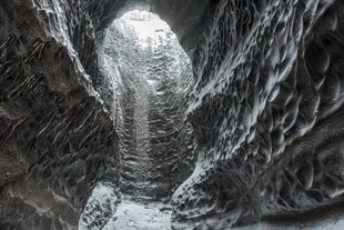 The entrance to Katla ice cave, with icy walls all around.