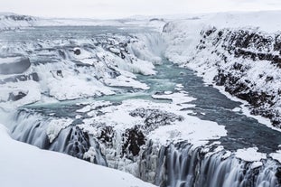 Gullfoss waterfall covered in snow and ice during winter in Iceland.