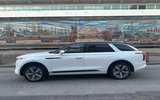 White SUV parked outside Reykjavik Cruise Terminal, ready for a private transfer service.