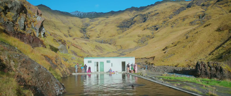 The couple in the movie Through Night and Day taking a dip in Seljavallalaug pool in Iceland