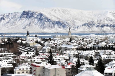 Snow covers Reykjavik and its surrounding landscapes.