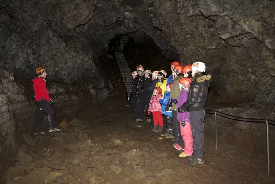 Tour group with headlamps inside Vatnshellir Lava Cave near Snaefellsjokull.