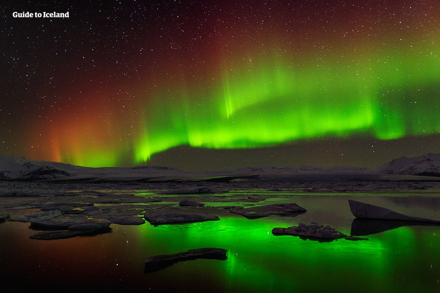 The northern lights shine in the sky above Diamond Beach near the Jokulsarlon glacier lagoon.