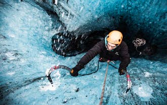 A person tries their hand at the exciting activity of ice climbing in Vatnajokull National Park.