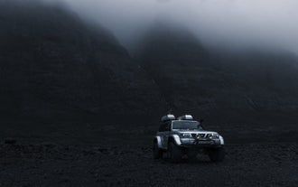 A super jeep parked on rough terrain near the Vatnajokull glacier.