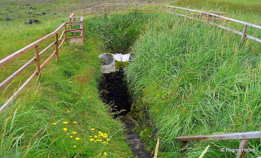 Írskabrunnur (Irish Well) in North Iceland, a historic stone well linked to Irish monks who may have settled in Iceland before Norse Vikings, surrounded by lush grass.