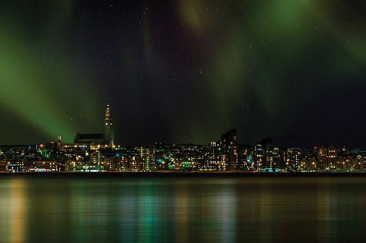 Zorza polarna stanowi majestatyczne tło dla krajobrazu Reykjaviku.