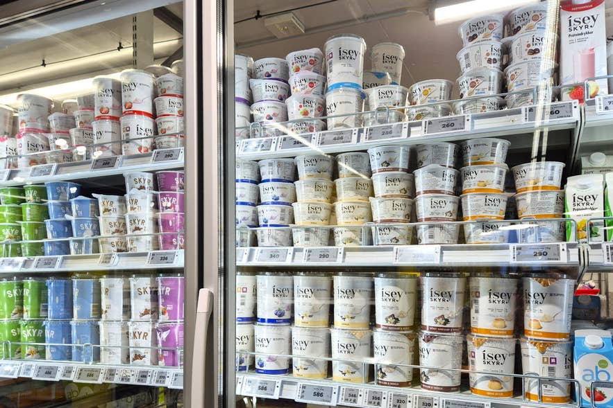 Skyr selection in an Iceland supermarket dairy fridge with multiple flavors of Isey Skyr yogurt