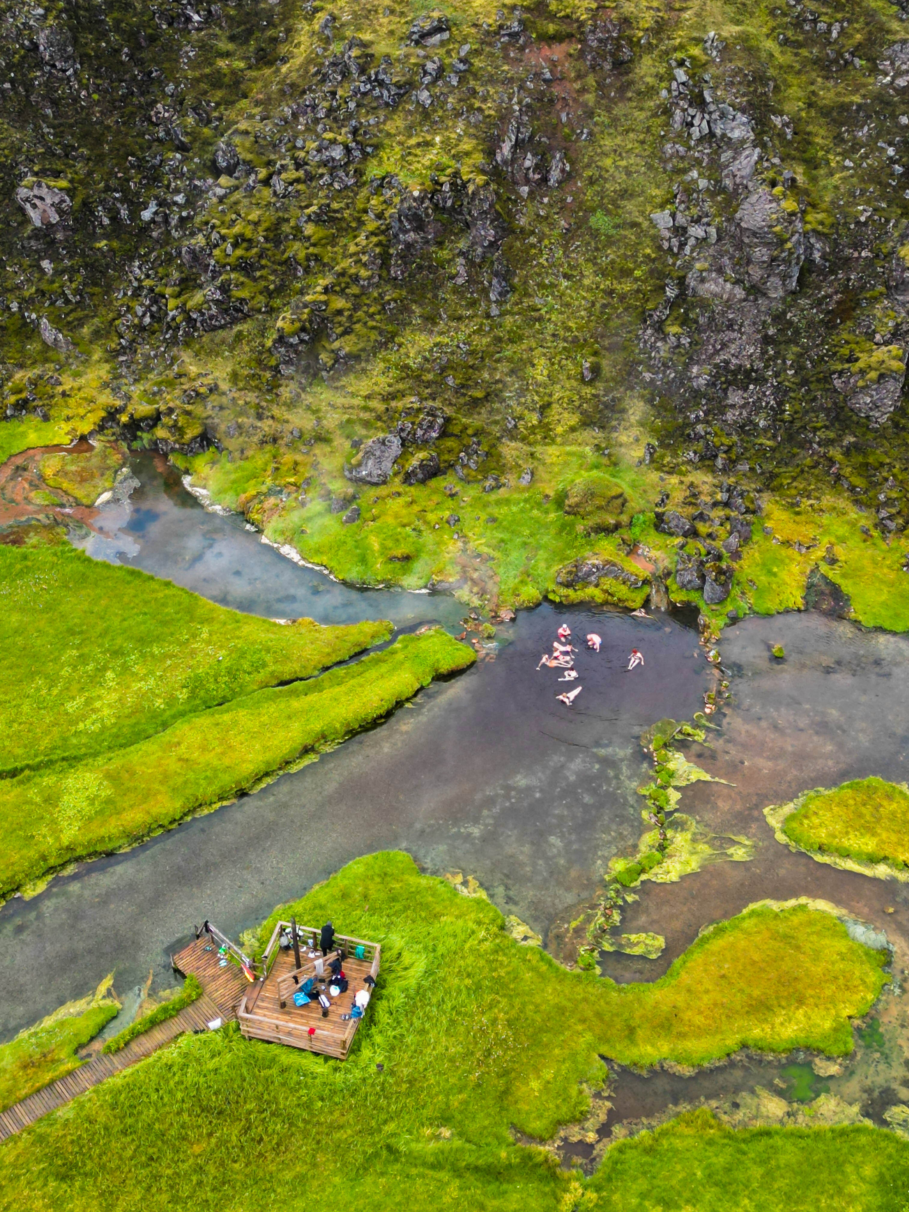 People bathing in the waters of a thermal spring in Landmannalaugar in Iceland.