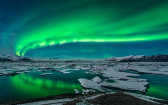 Witness the ethereal beauty of the northern lights dancing across the Icelandic sky.