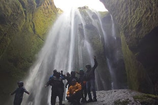 Standing in awe as the veil of mist surrounds you, revealing the captivating allure of the private Gljufrabui waterfall.