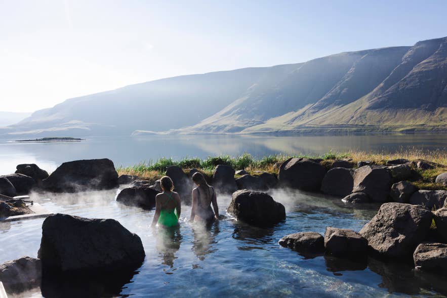 Steam rises from the natural pools of Hvammsvik.