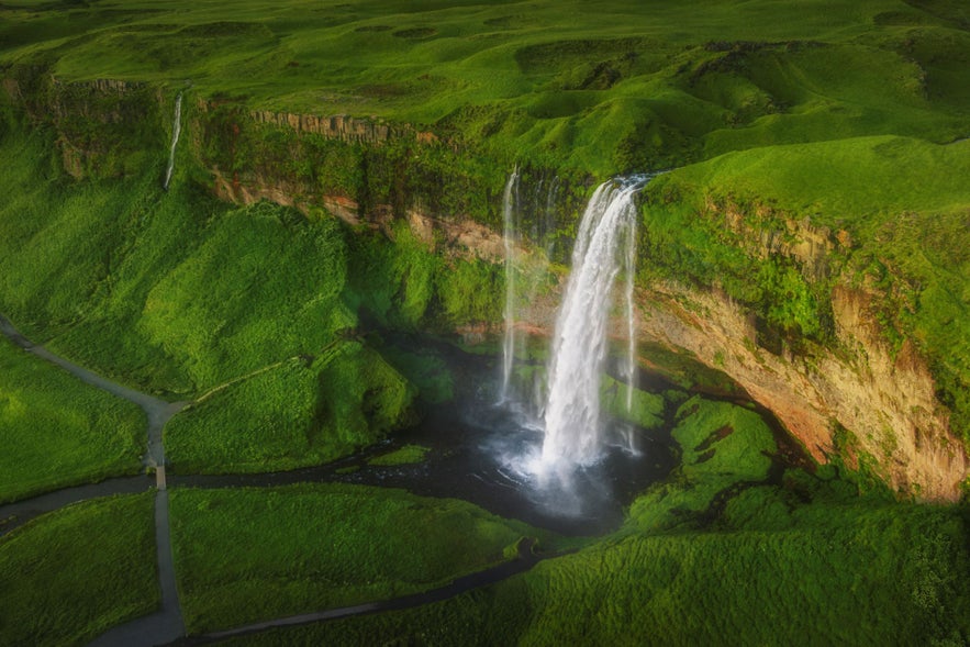 Seljalandsfoss waterfall cascades over a shallow cave