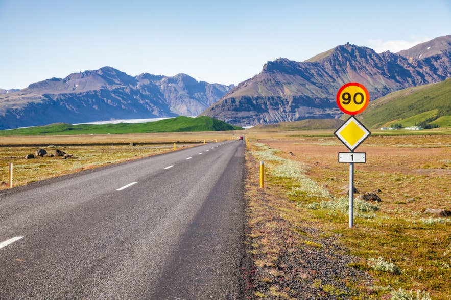Speed limit sign of 90 kilometers per hour along Route 1 Ring Road in rural Iceland.