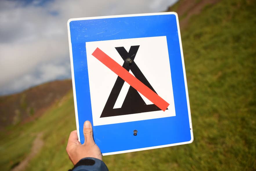 No camping sign in Icelandic Highlands, indicating camping is prohibited outside designated campsites.