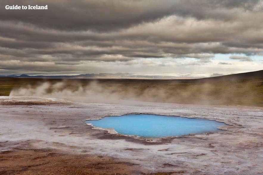 Hot spring and steaming geothermal pool in the Geysir Geothermal Area along Iceland’s Golden Circle.