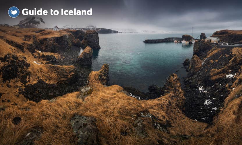 Rugged cliffs surround the Arnastapi village harbor on the Snaefellsnes Peninsula.