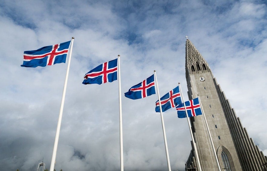 Icelandic flags waving by Hallgrimskirkja Church in Reykjavik on Independence Day, celebrated in Iceland in June.