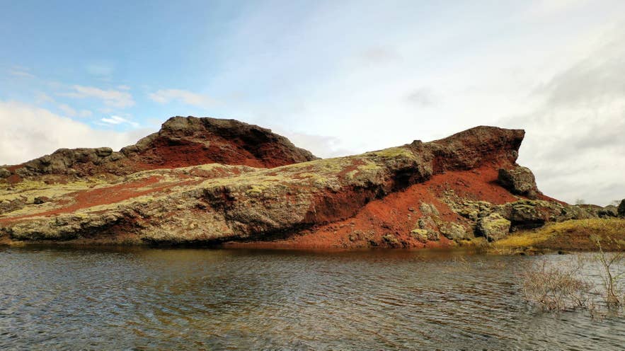 Red pseudocraters of Raudholar beside a lake near Reykjavik Red pseudocraters of Raudholar beside a lake near Reykjavik