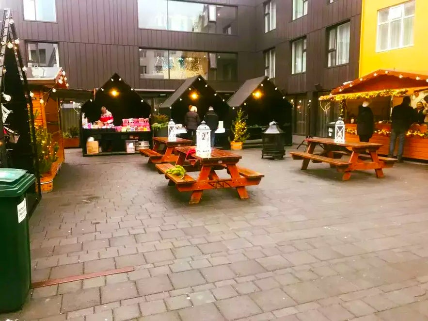 Christmas market in Reykjavik’s Hjartartorg square with vendors, benches, and holiday decor