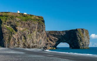 Dyrholaey Rock Arch rises above the ocean on Iceland’s South Coast.