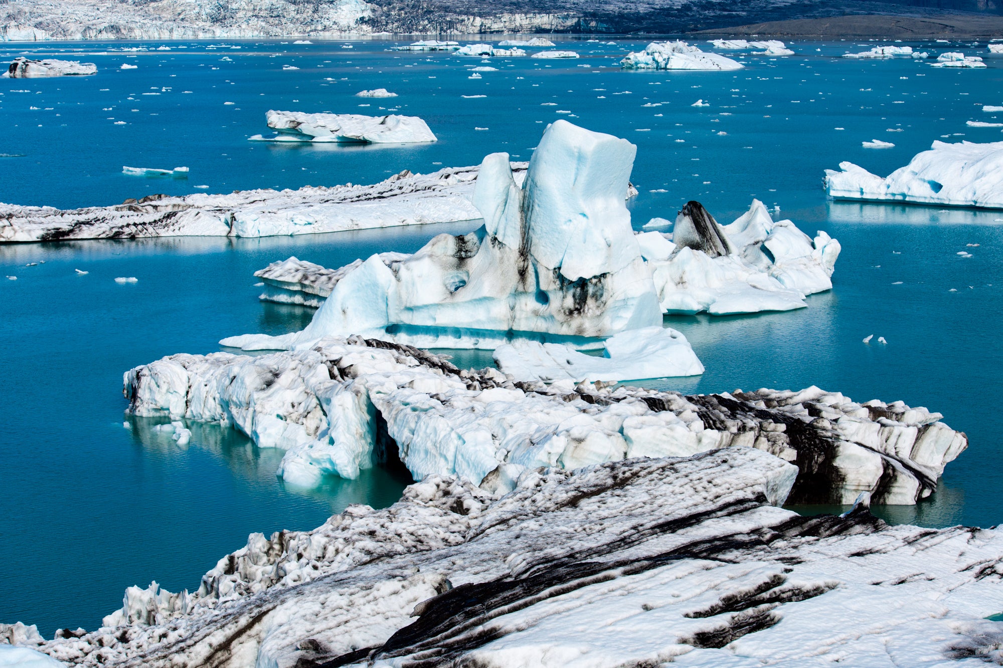 Witness the silent dance of icebergs in Jokulsarlon, where these frozen sculptures create a serene symphony on the tranquil waters.