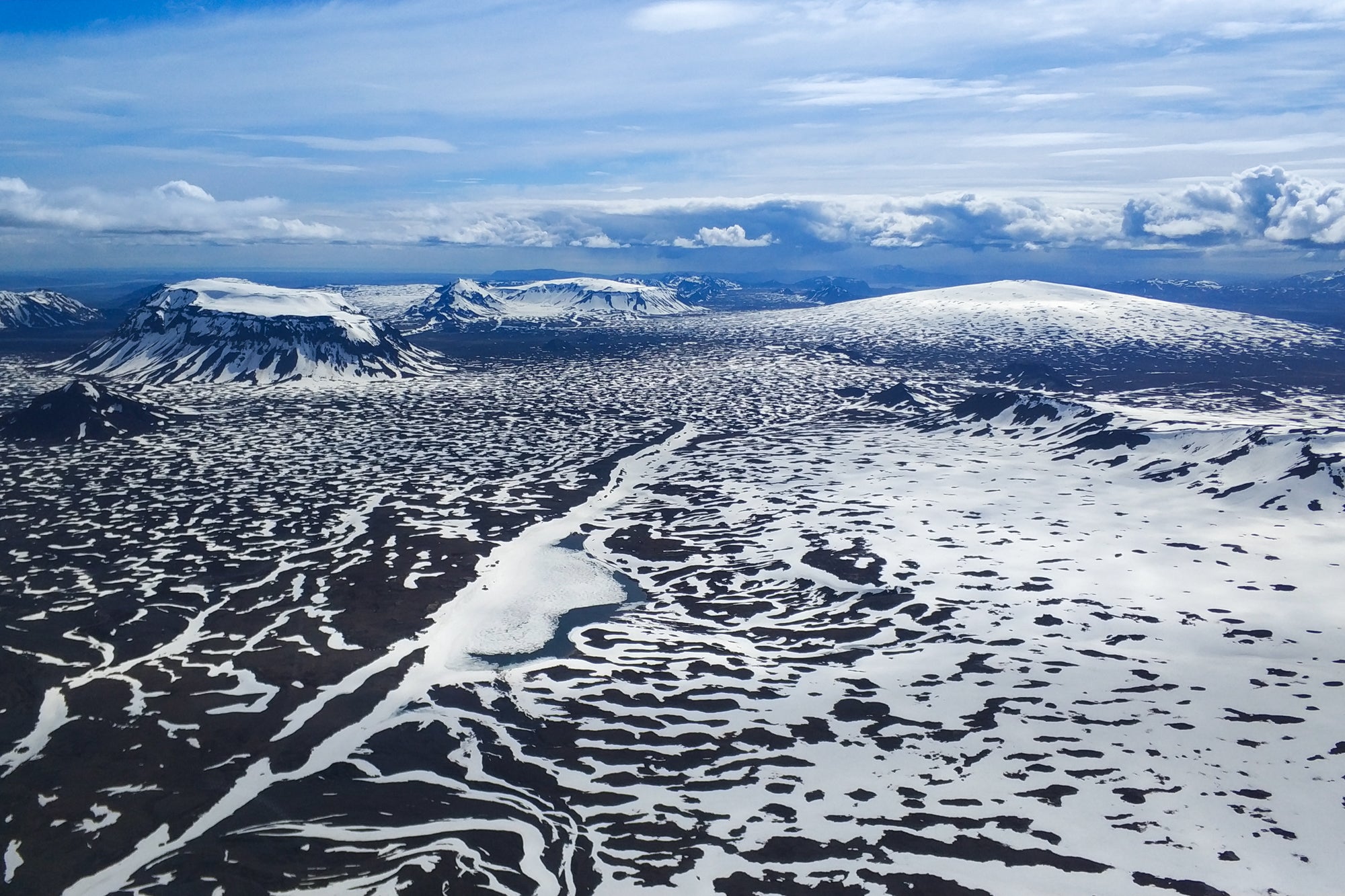 An aerial view of snow covered mountains and glaciers in Iceland.