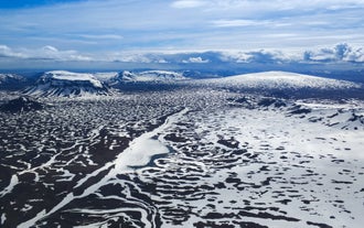 An aerial view of snow covered mountains and glaciers in Iceland.