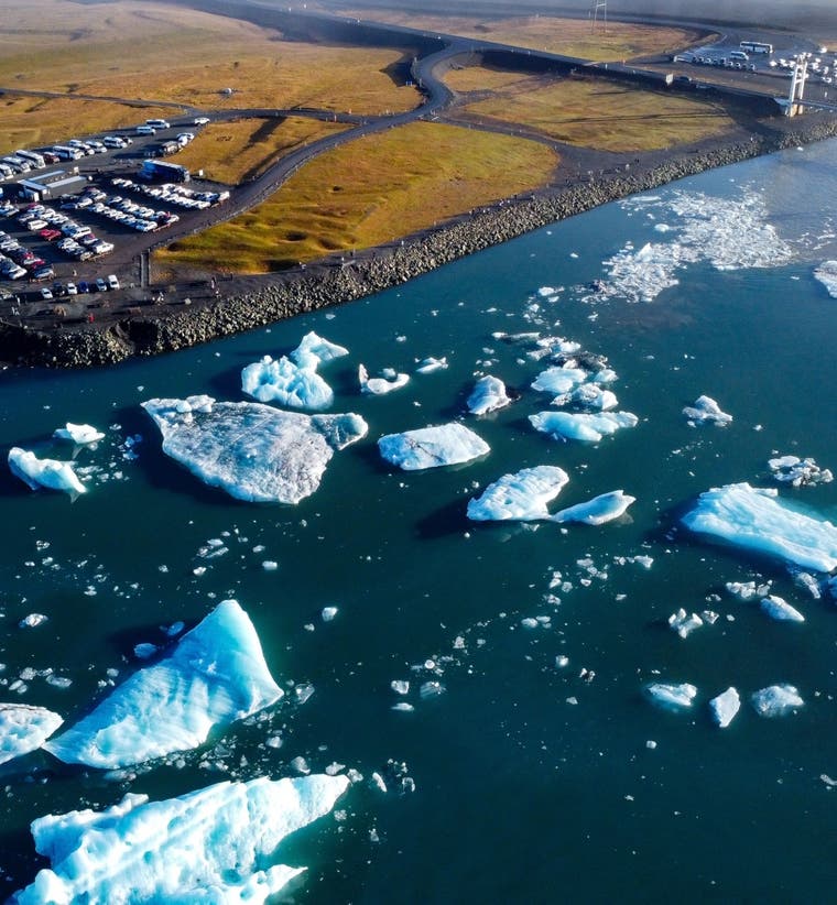Aerial view of Iceland’s Jokulsarlon lagoon and Diamond Beach with floating glacier icebergs on a summer day.