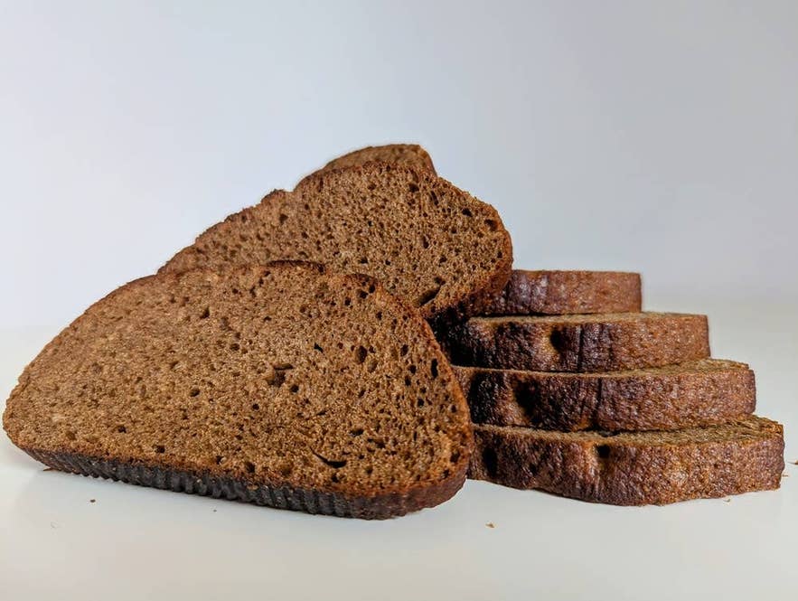 Slices of Icelandic rugbraud rye bread, a traditional grocery item travelers buy for sandwiches on an Iceland road trip.