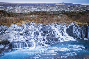 Discover the wonders of Hraunfossar, where beauty unfolds as streams gracefully flow over dark lava, a hidden gem in West Iceland.