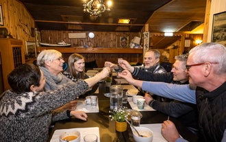A group of travelers toasting drinks during Christmas season in Reykjavik.