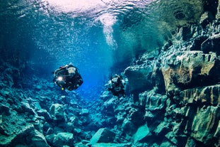 Two divers exploring the underwater beauty of Silfra fissure.