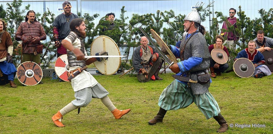 Live sword fight reenactment at the Viking Festival in Hafnarfjordur, Iceland in June, with costumed warriors and spectators.