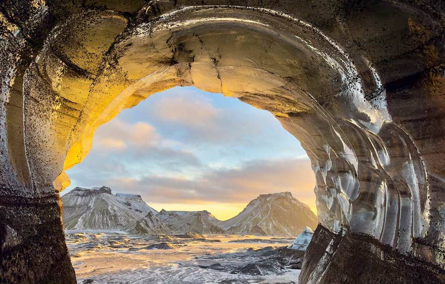 View looking out through the arched mouth of the Katla Ice Cave. View looking out through the arched mouth of the Katla Ice Cave.