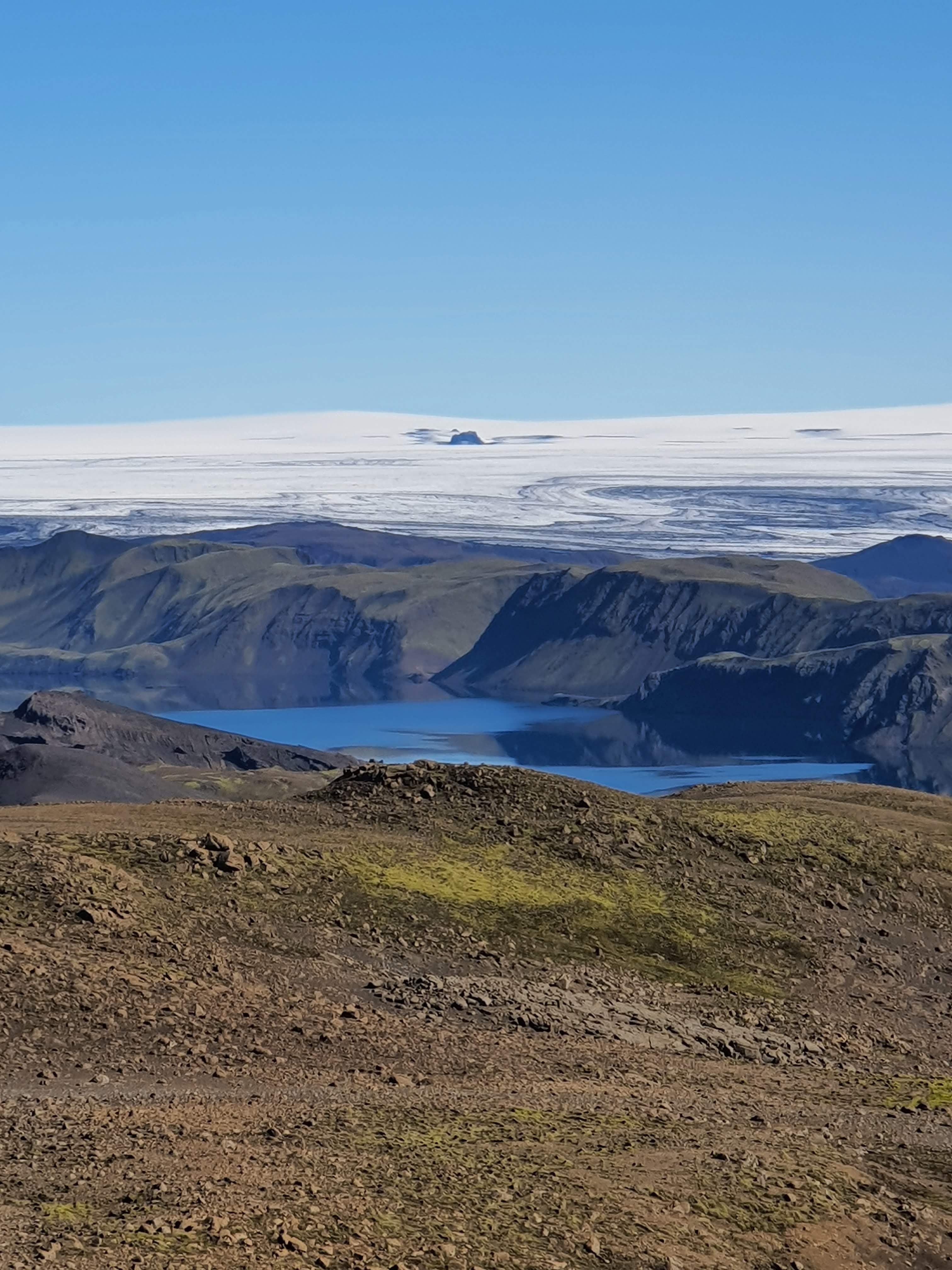 The Langisjor lake in the Icelandic Highlands, with a snowy plain in the background.