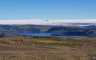 The Langisjor lake in the Icelandic Highlands, with a snowy plain in the background.