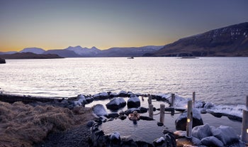 A woman relaxes in the Hvammsvik Hot Springs in Iceland.