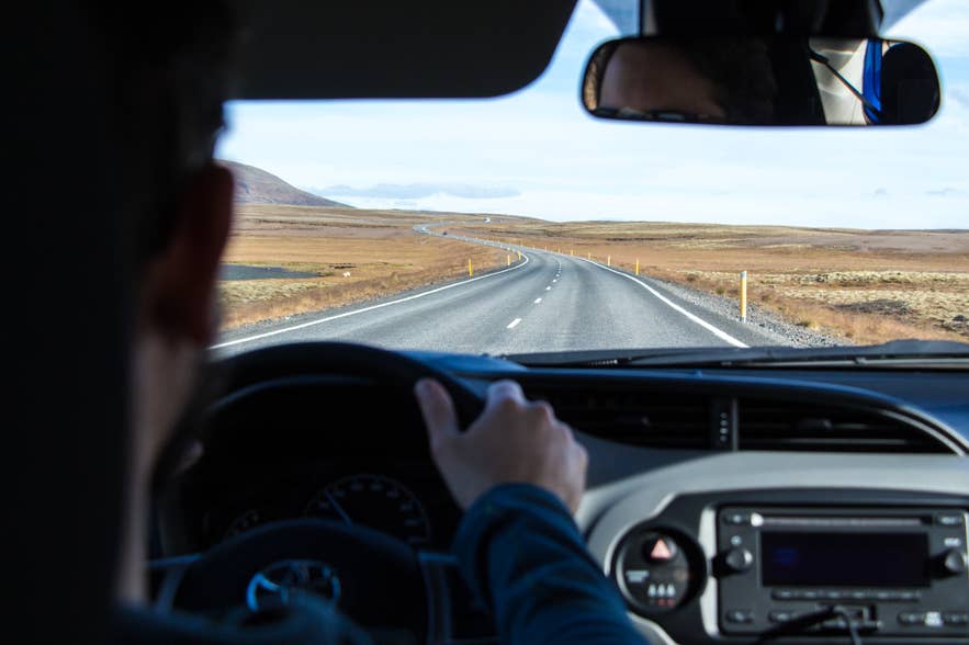 The inside of a car as a couple goes on a road trip through Iceland. 