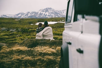 A couple enjoy mountain views in Iceland.