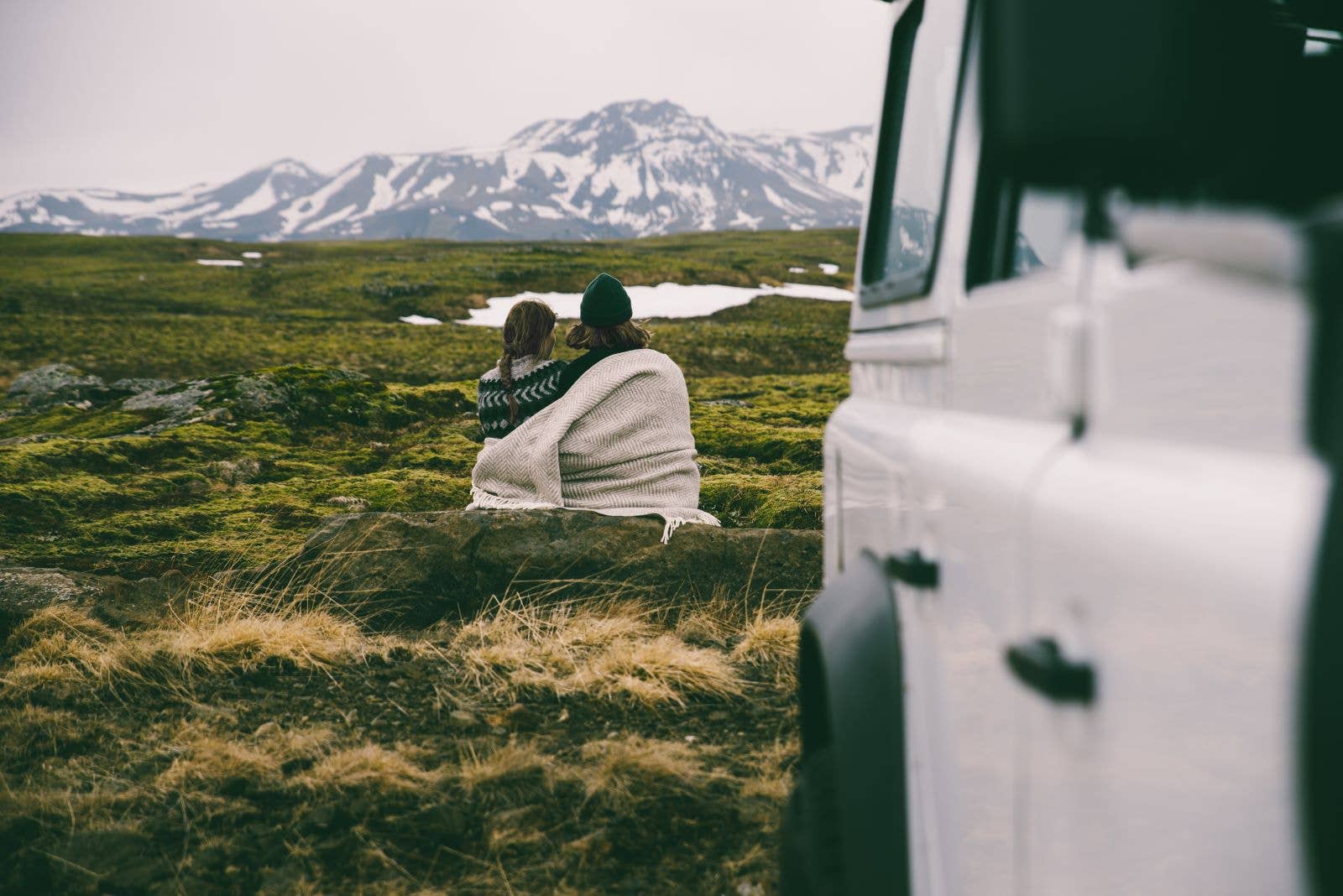 A couple enjoy mountain views in Iceland.