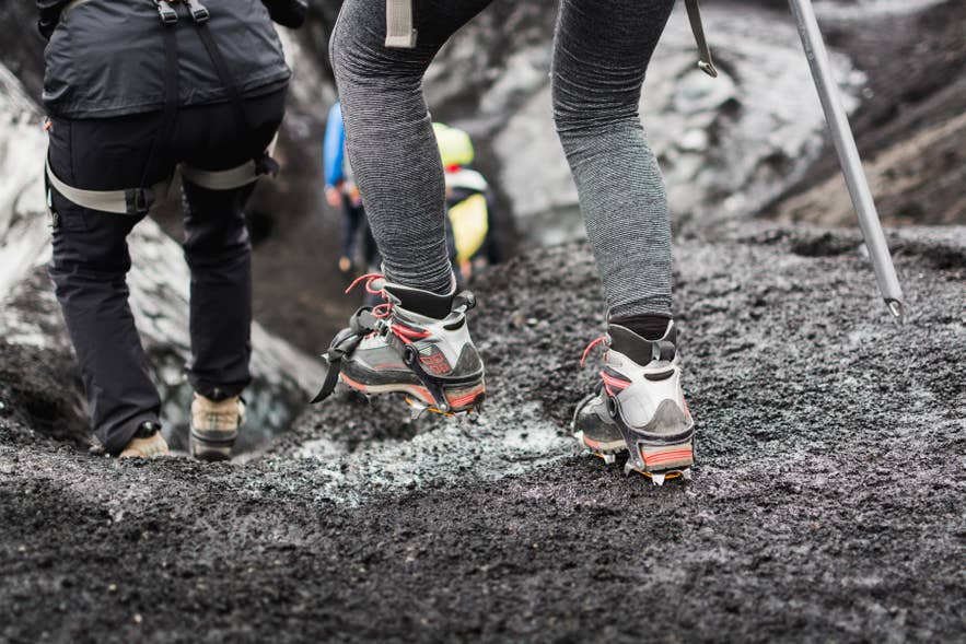 Close up of crampons on boots during glacier hiking tour in Iceland.