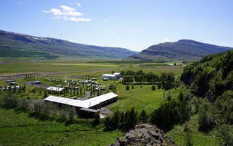 Fljotsdalsgrund framed by the majestic beauty of the Fljotsdalur valley, a harmonious blend of comfort and nature.