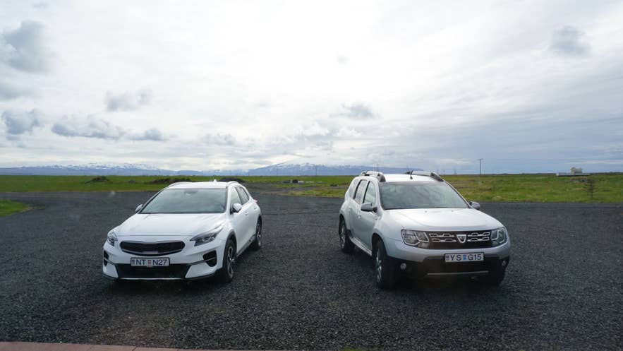 Rental cars parked on a gravel lot in Iceland