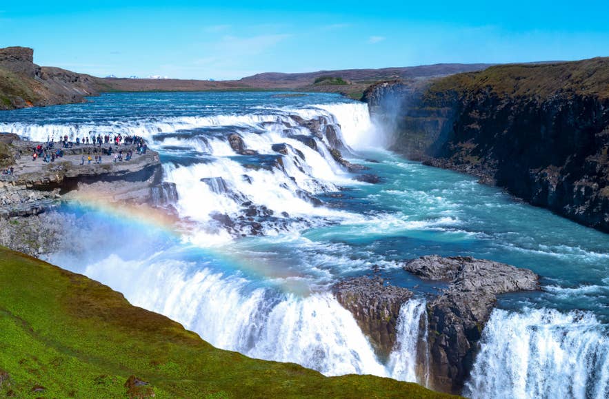 Gullfoss Waterfall on the Golden Circle with a rainbow in its spray, one of the best sights on a clear-sky day in Iceland.